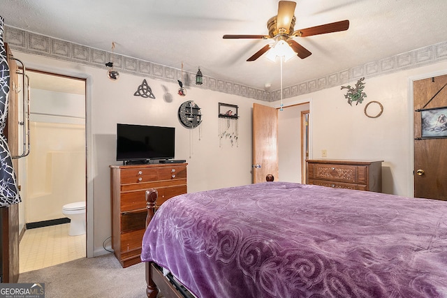 bedroom featuring ensuite bath, a textured ceiling, and ceiling fan