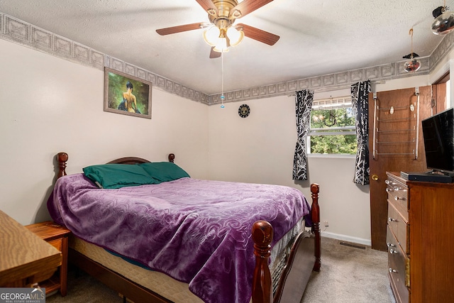 bedroom featuring a textured ceiling, ceiling fan, and carpet flooring