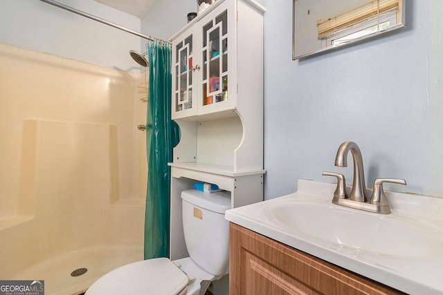 bathroom featuring vanity, toilet, and curtained shower