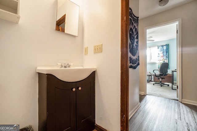 bathroom featuring wood-type flooring, vanity, and ceiling fan