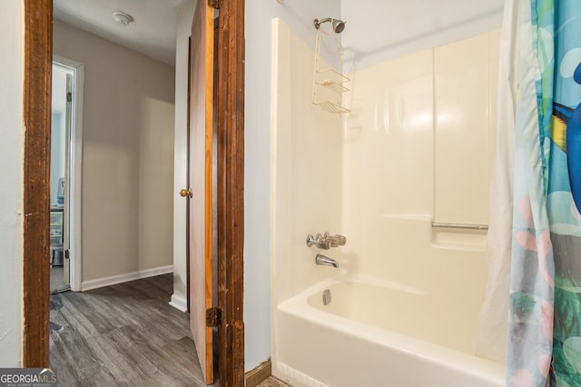 bathroom with hardwood / wood-style floors and shower / bath combination with curtain