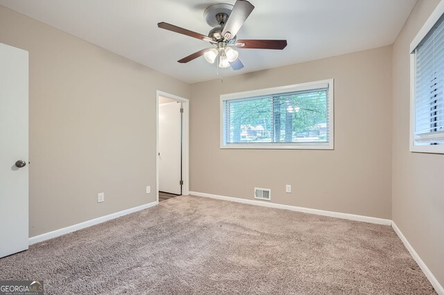 unfurnished bedroom featuring ceiling fan and carpet floors