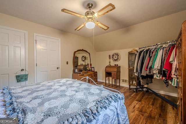 bedroom featuring vaulted ceiling, dark wood-type flooring, and ceiling fan