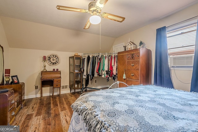 bedroom with ceiling fan, vaulted ceiling, cooling unit, and dark hardwood / wood-style flooring