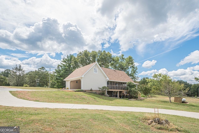 rear view of house featuring a wooden deck and a yard