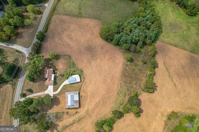 wooden deck featuring a garage, a lawn, and an outbuilding