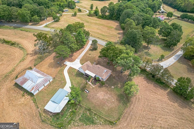 birds eye view of property with a rural view