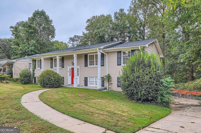 bi-level home featuring a front yard and central AC