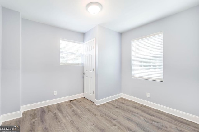 unfurnished room with light hardwood / wood-style floors