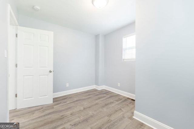 spare room featuring light hardwood / wood-style floors