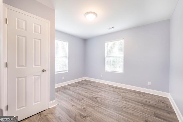 empty room with light hardwood / wood-style floors