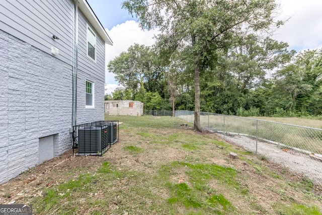 view of yard featuring central air condition unit