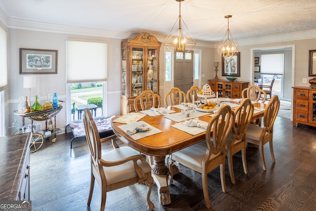 dining space featuring a chandelier, dark wood-type flooring, and crown molding