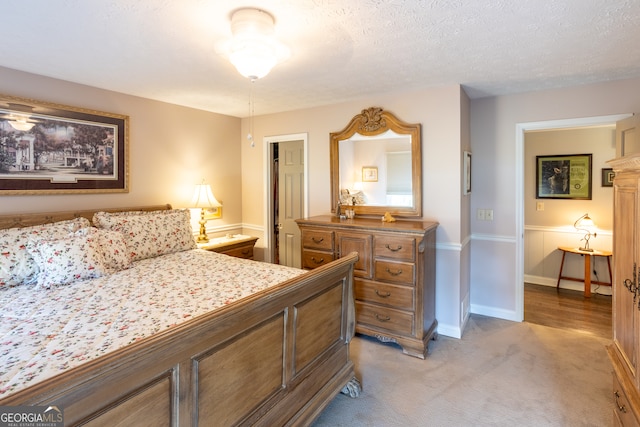 carpeted bedroom featuring a textured ceiling