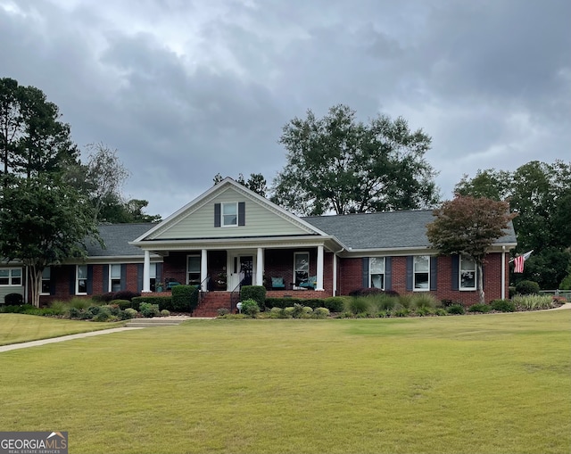 view of front of house with a front yard and a porch