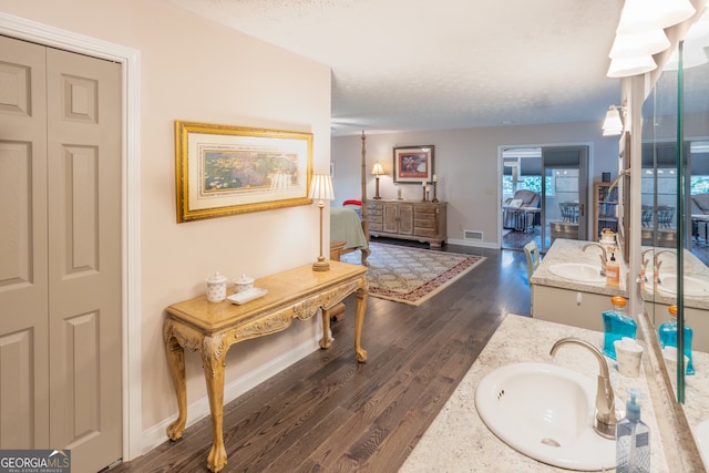 bathroom with vanity, hardwood / wood-style floors, and a textured ceiling