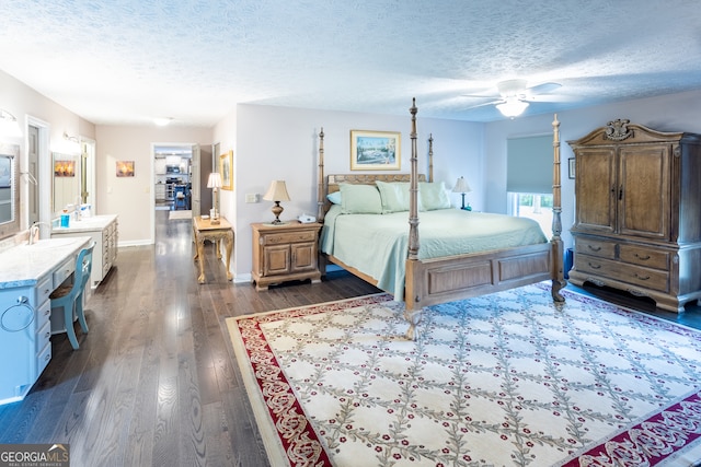 bedroom featuring ceiling fan, a textured ceiling, sink, and dark hardwood / wood-style flooring