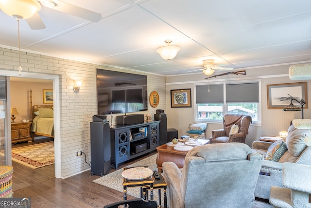 living room featuring ceiling fan, brick wall, and dark hardwood / wood-style floors