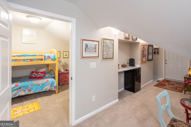 bedroom with vaulted ceiling and light carpet