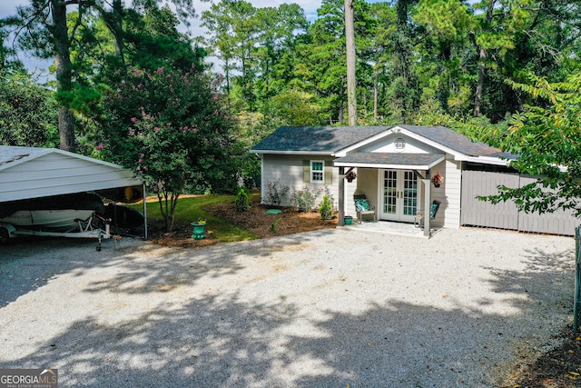 view of front of property with french doors and a carport