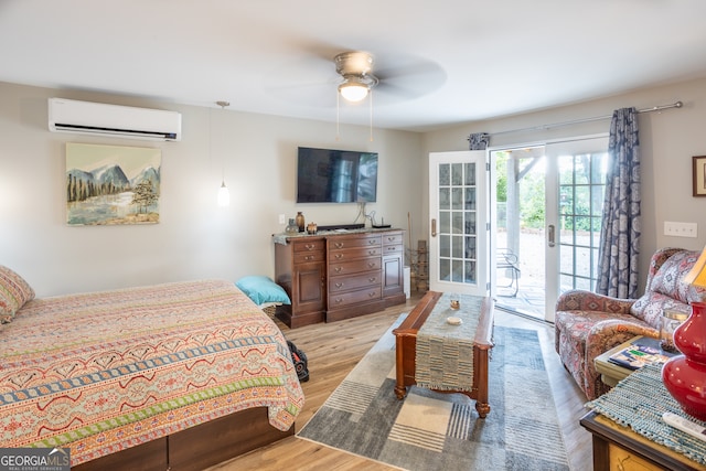 bedroom with access to outside, ceiling fan, french doors, light wood-type flooring, and a wall mounted air conditioner