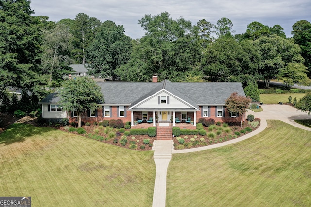 view of front of house with a front yard and a porch