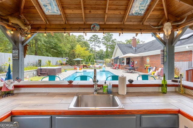 view of pool with a patio, a gazebo, and sink