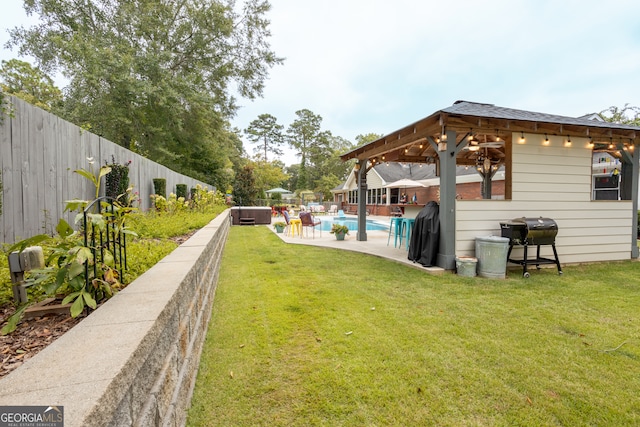 view of yard with a fenced in pool and a patio area