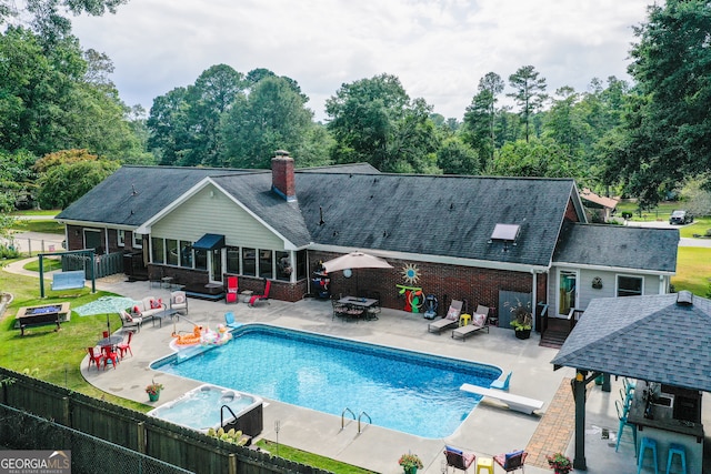 view of pool with a patio area and a diving board