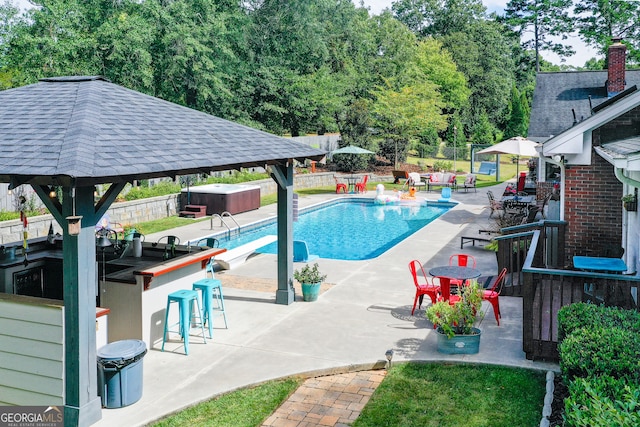 view of pool featuring an outdoor bar and a patio area