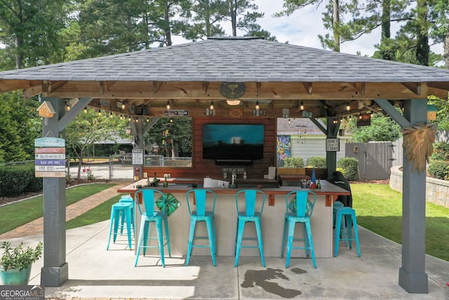 view of patio / terrace featuring an outdoor bar and a gazebo