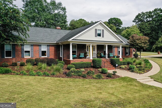 view of front of property with a front lawn and a porch