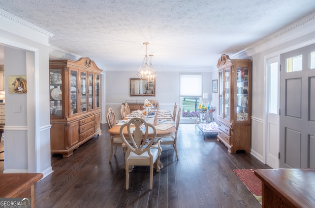 dining space with a notable chandelier, a textured ceiling, crown molding, and dark hardwood / wood-style flooring