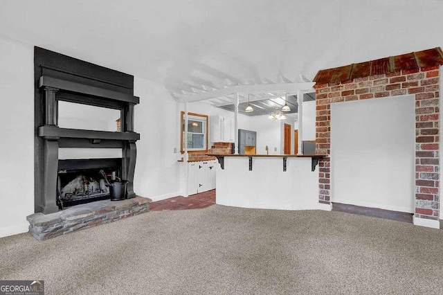 unfurnished living room featuring a fireplace and dark carpet