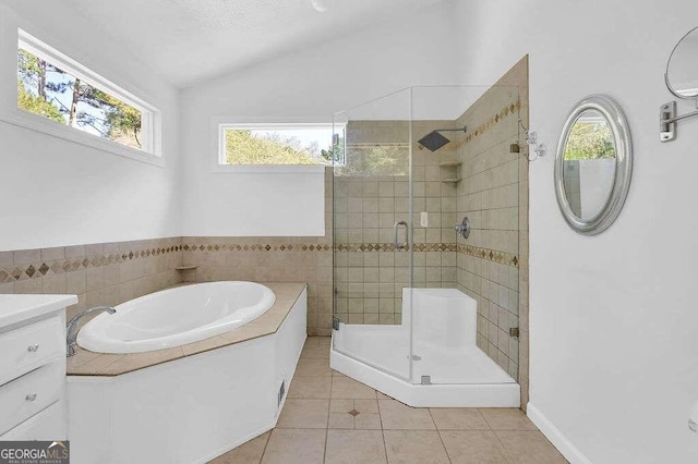 bathroom with lofted ceiling, vanity, plus walk in shower, and tile patterned floors