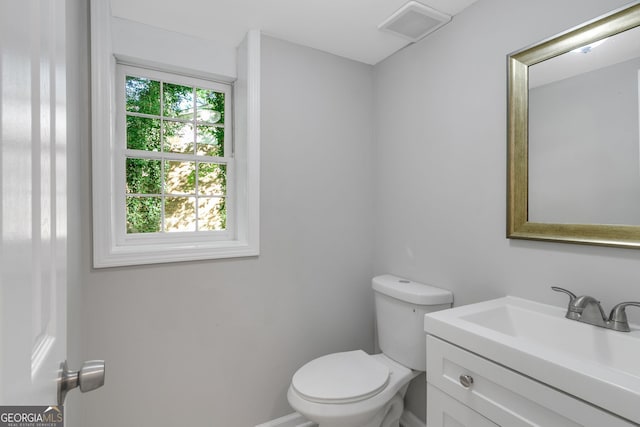 bathroom with vanity, plenty of natural light, and toilet