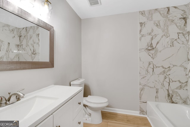 full bathroom with wood-type flooring, vanity, toilet, and shower / washtub combination