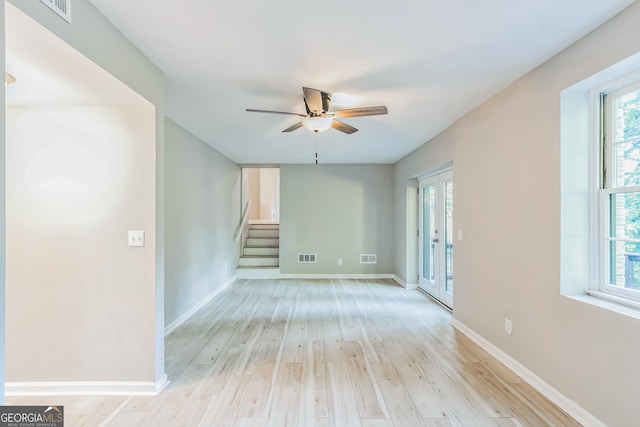 spare room featuring light hardwood / wood-style flooring, ceiling fan, and plenty of natural light