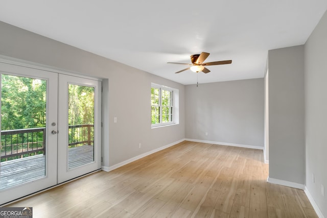 unfurnished room featuring ceiling fan, light wood-type flooring, and french doors