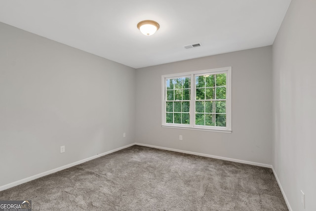 unfurnished room with light carpet