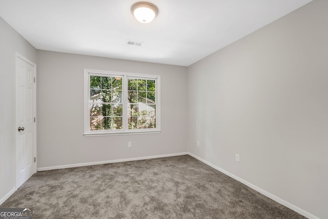 unfurnished room featuring carpet