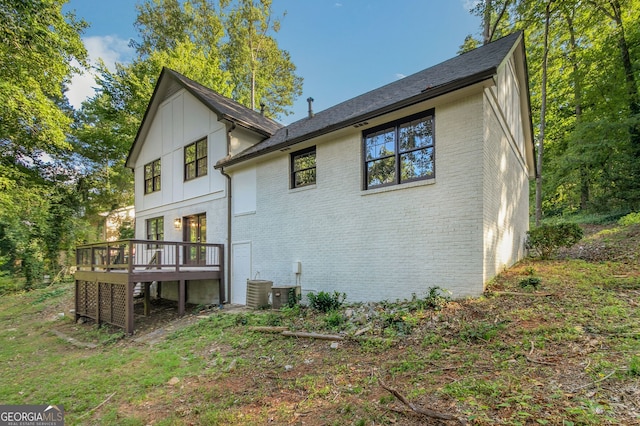 back of house with a wooden deck