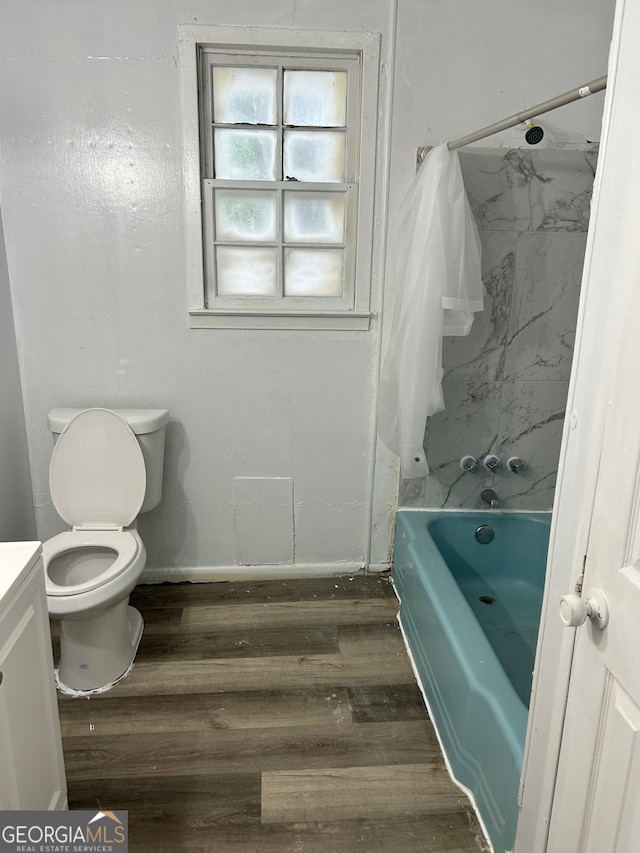 full bathroom featuring toilet, shower / tub combo with curtain, vanity, and hardwood / wood-style floors