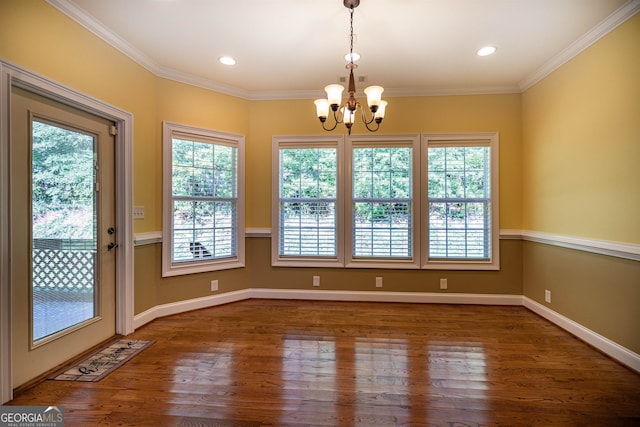 unfurnished dining area featuring a healthy amount of sunlight, ornamental molding, and dark hardwood / wood-style flooring