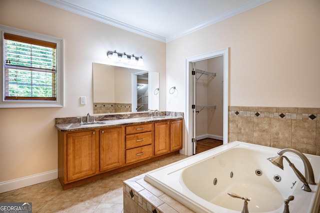 bathroom with crown molding, tiled tub, vanity, and tile patterned flooring