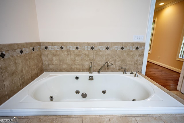 bathroom featuring tiled tub and hardwood / wood-style flooring