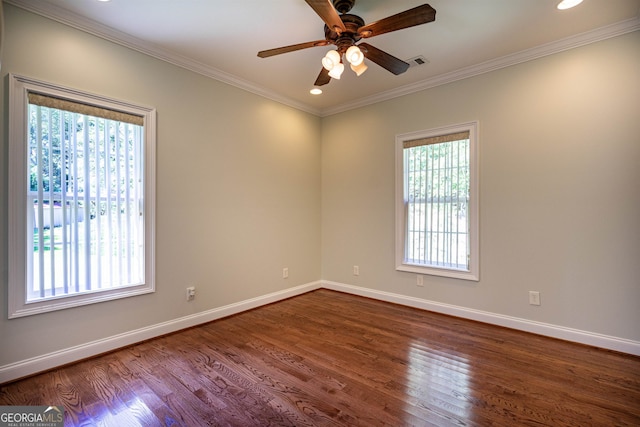 empty room featuring a healthy amount of sunlight, wood-type flooring, and ceiling fan