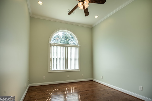 empty room featuring ceiling fan, dark hardwood / wood-style floors, and ornamental molding