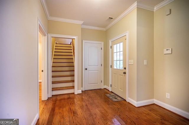 entrance foyer featuring hardwood / wood-style flooring and crown molding