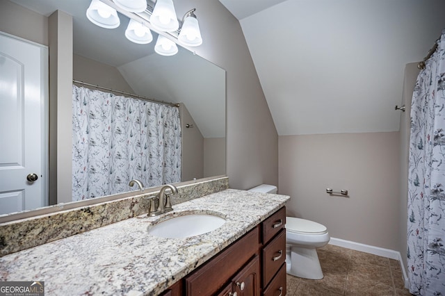 bathroom featuring lofted ceiling, vanity, toilet, and tile patterned floors